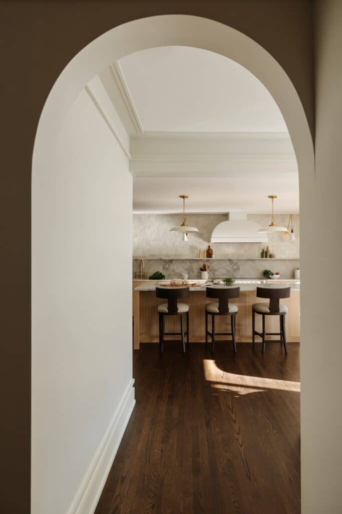 Beautifully staged kitchen with bar seating, modern decor, and warm lighting.