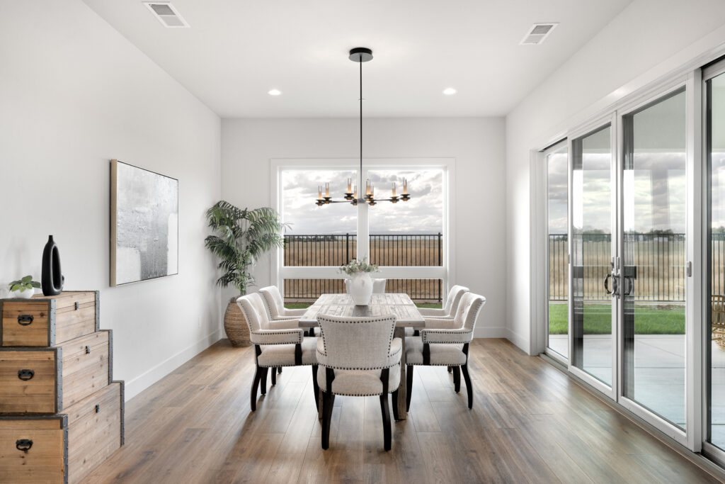 Dining room table in front of a big window
