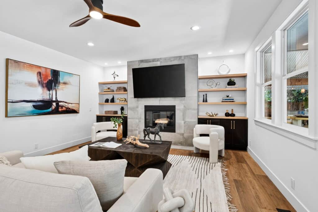 Contemporary California family room with chairs flanking fireplace